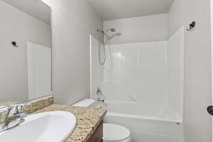 Hall bathroom featuring vanity and shower / washtub combination