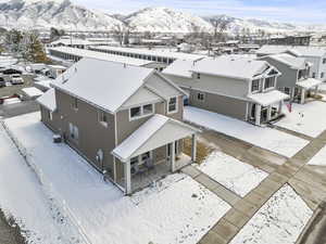 Snowy aerial view featuring a mountain view and a residential view