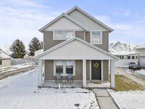 View of front of home with a porch, a mountain view