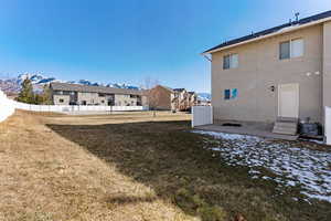 Back of property with a patio area, a mountain view, and stucco siding