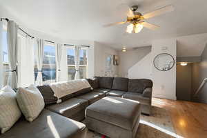Living room with hardwood / wood-style floors and a ceiling fan