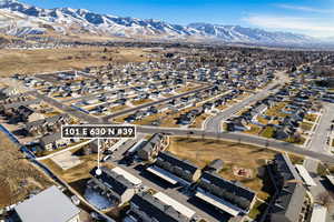 Aerial view of property's location with nearby suburban area and a mountainous background