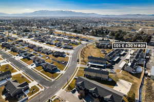 Aerial view of property's location featuring nearby suburban area and mountains