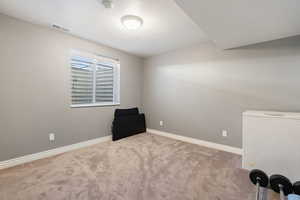 Unfurnished room featuring light colored carpet and a textured ceiling