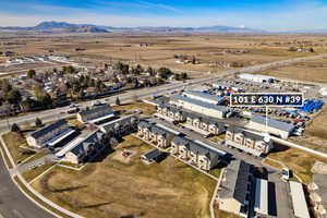 Aerial view of property's location with mountains and nearby suburban area