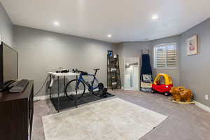 Recreation room with carpet floors and recessed lighting