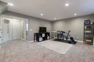 Exercise area with light colored carpet and recessed lighting