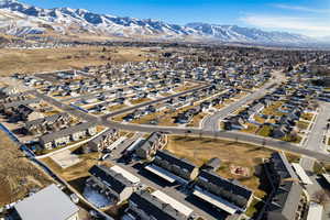 Aerial overview of property's location featuring mountains and nearby suburban area