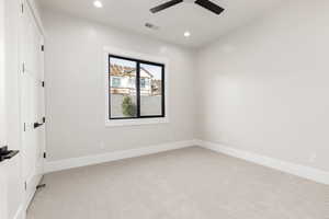 Spare room featuring light carpet, recessed lighting, and a ceiling fan