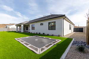 Rear view of property with a patio, a fenced backyard, and stucco siding
