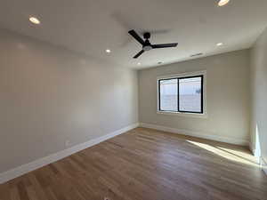 Empty room featuring light wood-style floors, recessed lighting, and a ceiling fan