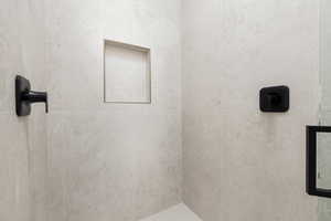 Bathroom featuring a tile shower