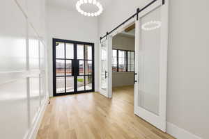Entryway with a barn door and wood finished floors