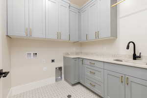 Laundry room featuring hookup for a gas dryer, hookup for a washing machine, electric dryer hookup, and cabinet space