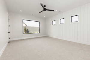 Empty room with light carpet, ceiling fan, and recessed lighting
