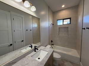 Bathroom featuring vanity, washtub / shower combination, and recessed lighting
