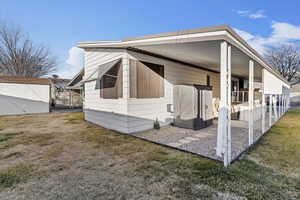 View of side of home featuring a lawn