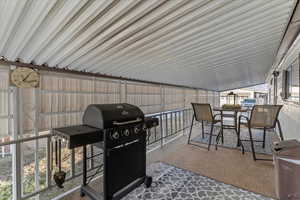 View of patio featuring a grill and outdoor dining area