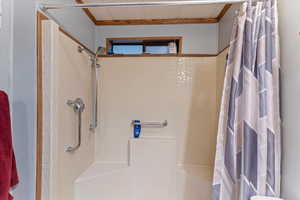 Full bathroom featuring a tile shower