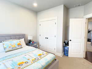 Bedroom featuring a closet and light carpet
