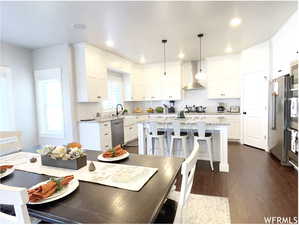 Dining room with dark wood-style floors and recessed lighting