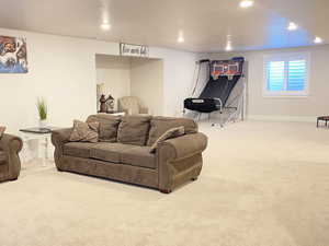 Living area with carpet floors and recessed lighting