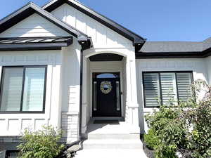 Doorway to property with stone siding