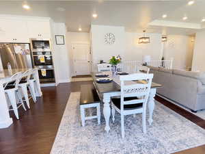 Dining room featuring dark wood-type flooring and suspended lighting