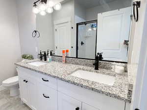 Bathroom with a shower stall and double vanity