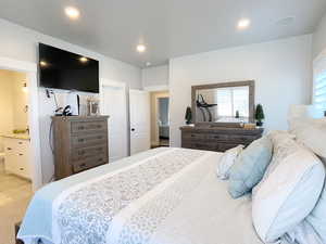 Bedroom with ensuite bathroom, a closet, and recessed lighting