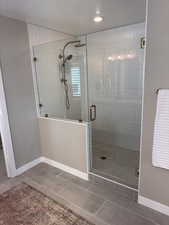 Full bath featuring a shower stall and tile patterned floors