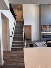 Stairway featuring a fireplace and wood finished floors