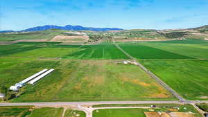 Overview of rural landscape with a mountainous background and large plots for crops