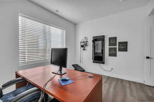 Office with light wood-style flooring and baseboards
