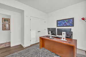 Office area with baseboards and wood finished floors