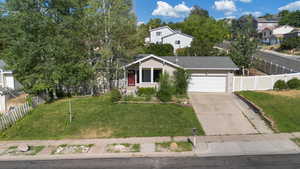 View of front of property featuring an attached garage, driveway, and brick siding