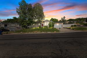 View of front of house featuring driveway, a garage, and a residential view