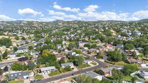 Aerial view of property's location featuring a mountain backdrop and nearby suburban area