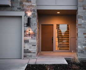 Entrance to property with stone siding