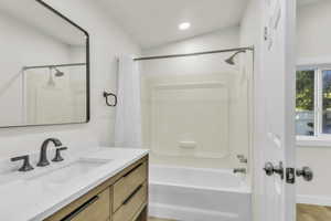 Full bath with vanity and shower / bath combo
