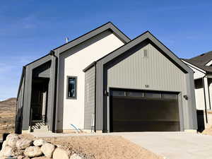View of front of property with driveway and a garage