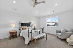 Carpeted bedroom featuring vaulted ceiling, a ceiling fan, and recessed lighting