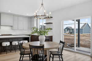 Dining room featuring light wood-style flooring and suspended lighting