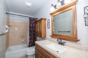 Full bath featuring vanity and shower / bath combo with shower curtain