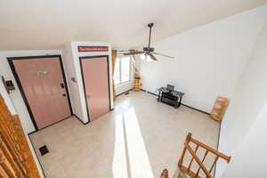 Foyer entrance with a ceiling fan and light tile patterned flooring