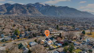 East-facing aerial view of the surrounding residential area with mountain backdrop.