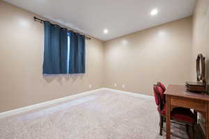 Carpeted office space featuring baseboards and recessed lighting