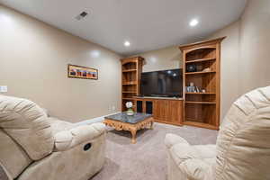 Living room featuring light carpet and recessed lighting