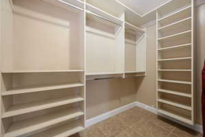 Walk in closet featuring light tile patterned floors