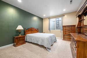 Bedroom featuring light colored carpet and recessed lighting